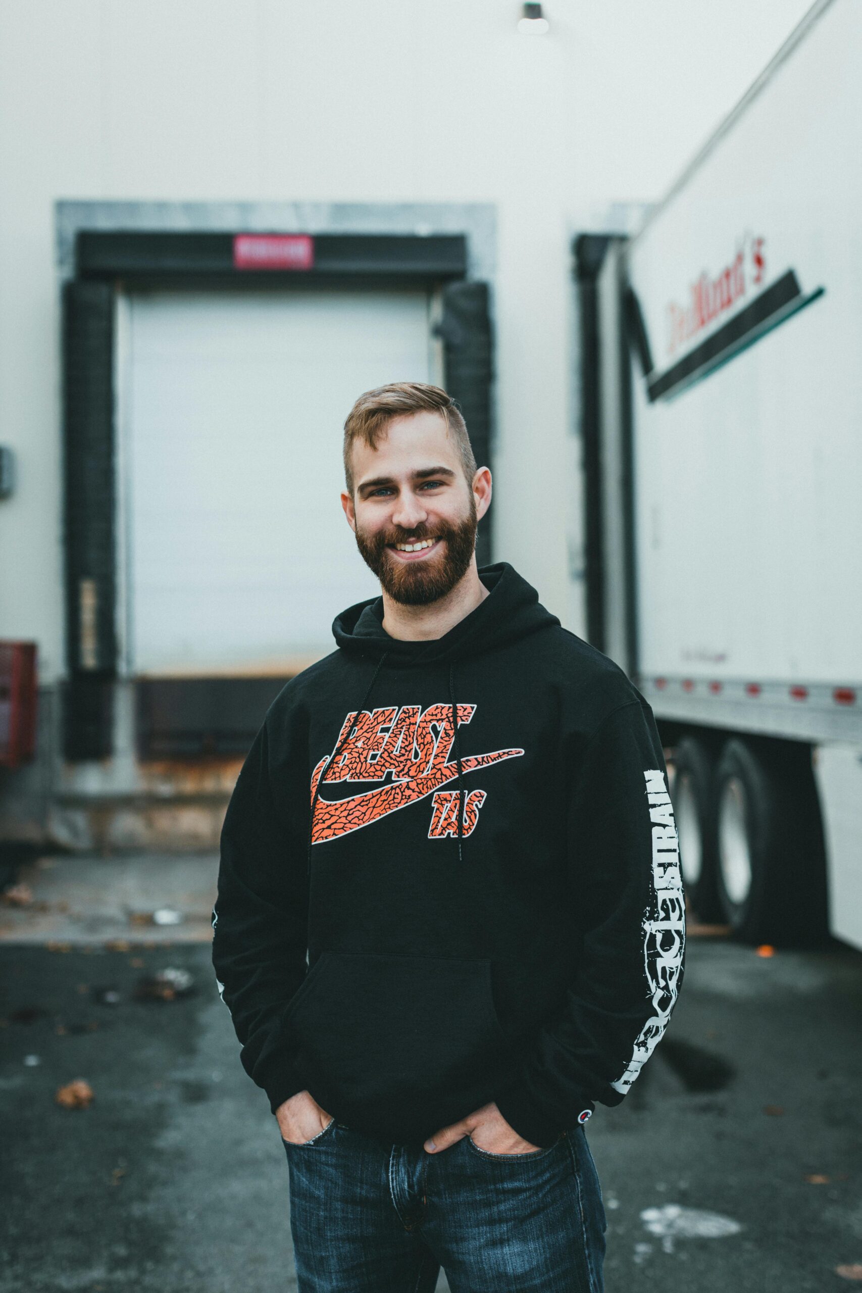 Man in Black Hoodie Standing next to Truck